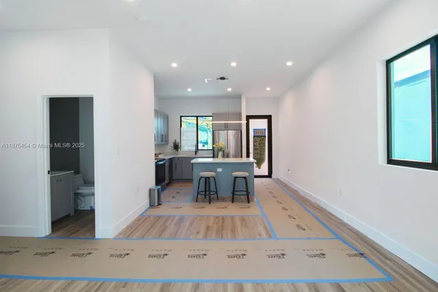 a view of kitchen with dining area and windows