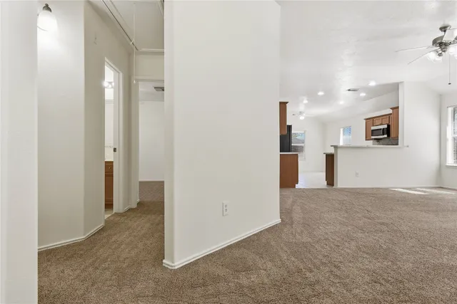 a view of a big room with closet and windows