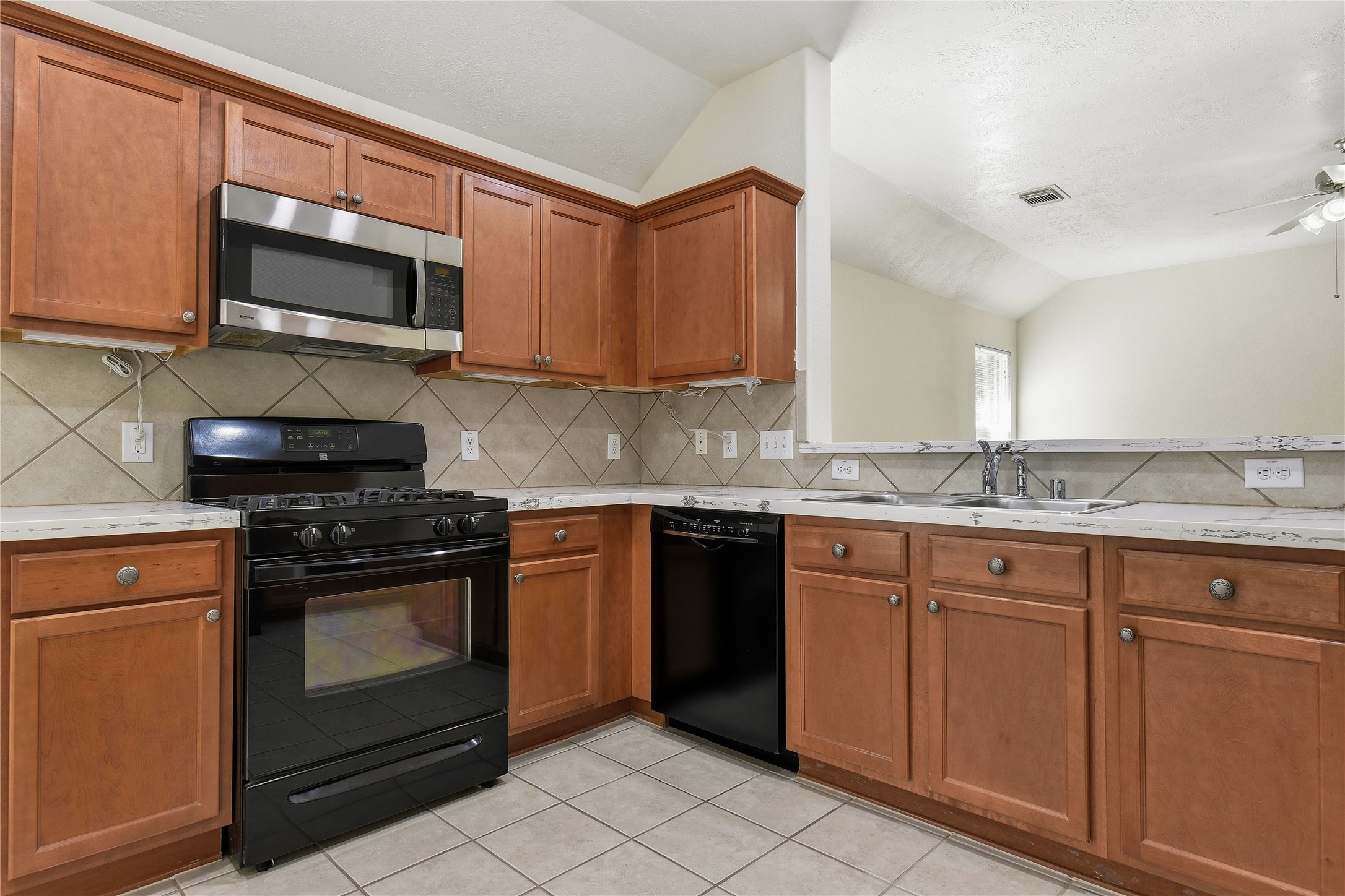5417 Summer Spring Lane Rosharon, TX 77583 - Photo 6 of 16 a kitchen with granite countertop a stove top oven microwave and cabinets