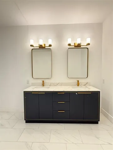 a bathroom with a double vanity sink and mirror