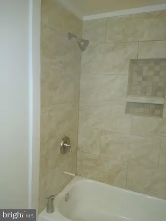a bathroom with a shower and a bathtub