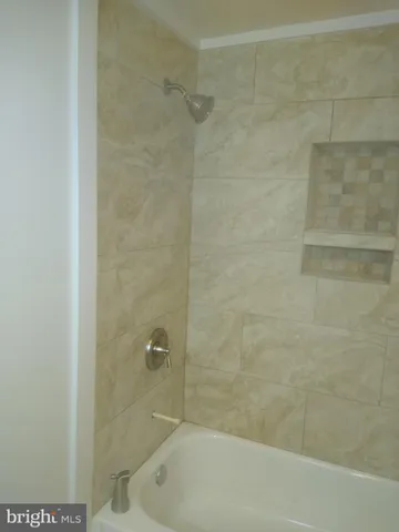 a bathroom with a shower and a bathtub