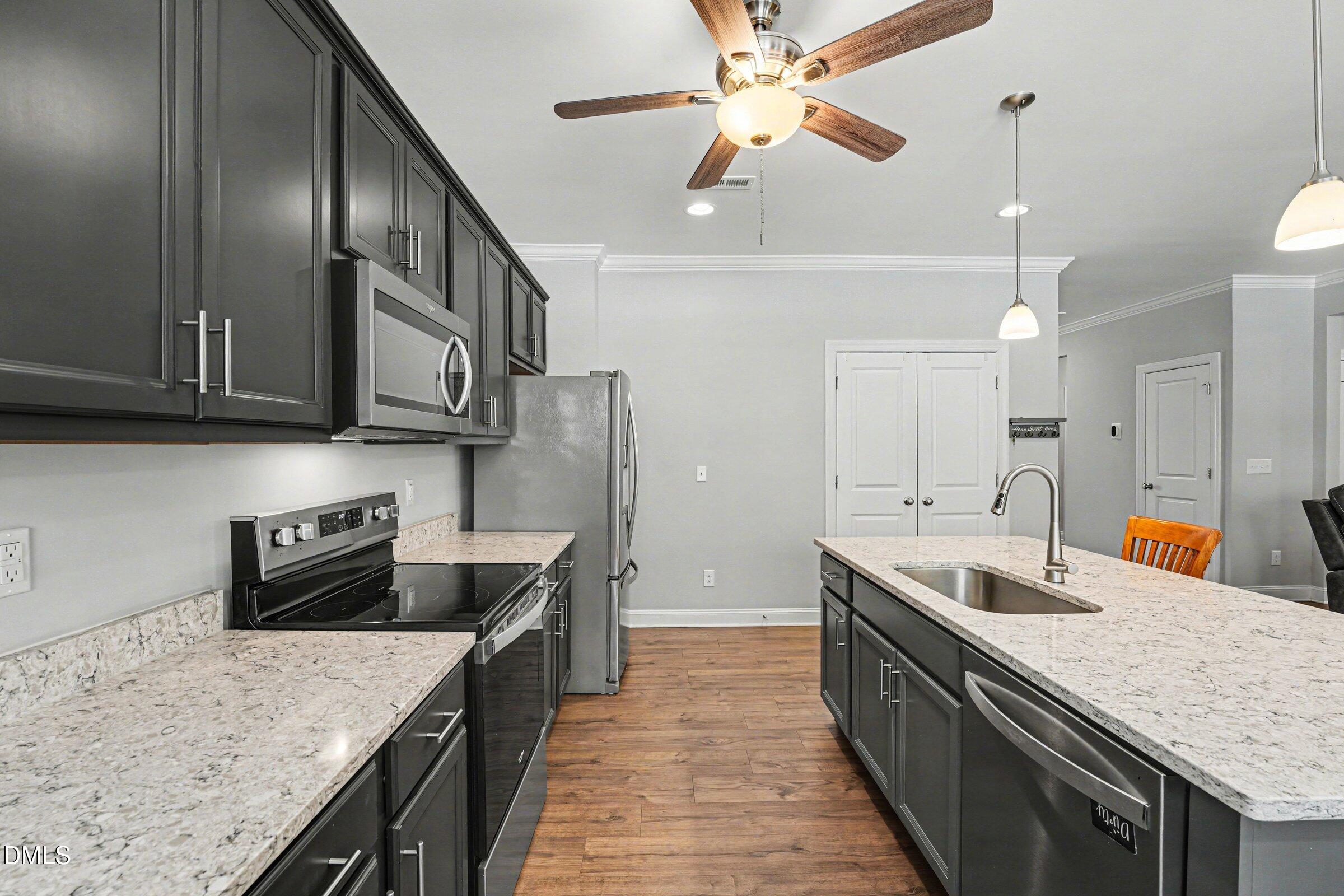 130 Aylebury Ridge Zebulon, NC 27597 - Photo 16 of 41 a kitchen with stainless steel appliances granite countertop a sink a stove oven a counter top space and cabinets