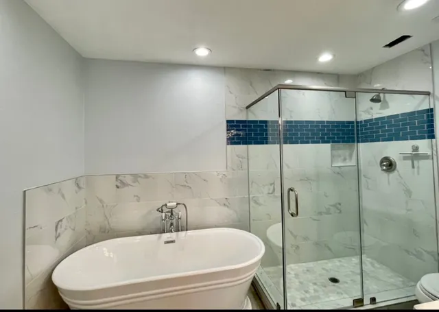 a bed sitting in a spacious bedroom next to a window