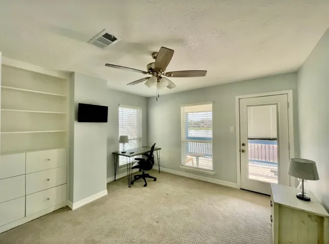 a bedroom with a bed and a tv on the dresser