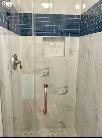 a bathroom with a granite countertop sink a toilet and shower