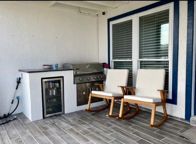 a living room with furniture and a floor to ceiling window