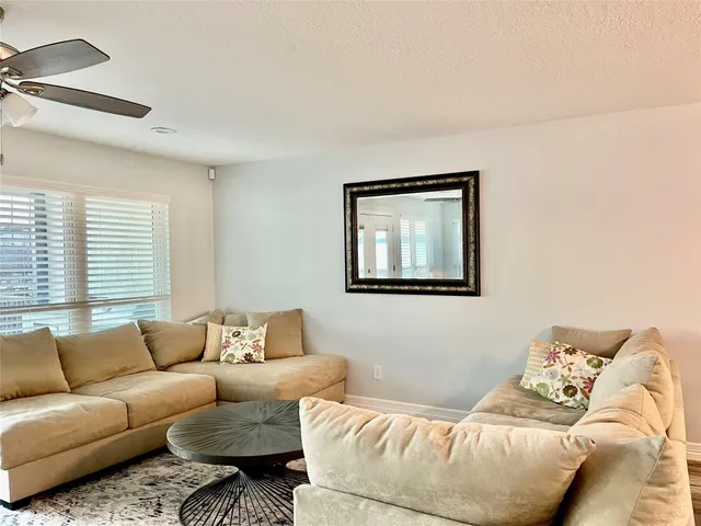 a bedroom with a bed a couch and a potted plant