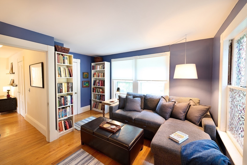 20 Manning Street, Unit 2 Ipswich, MA 01938 - Photo 13 of 27 a living room with furniture and a bookshelf with wooden floor