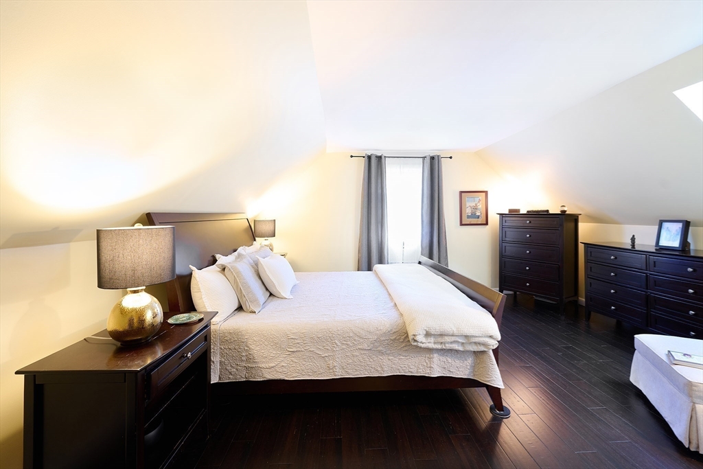 20 Manning Street, Unit 2 Ipswich, MA 01938 - Photo 17 of 27 a bedroom with a bed and wooden floor