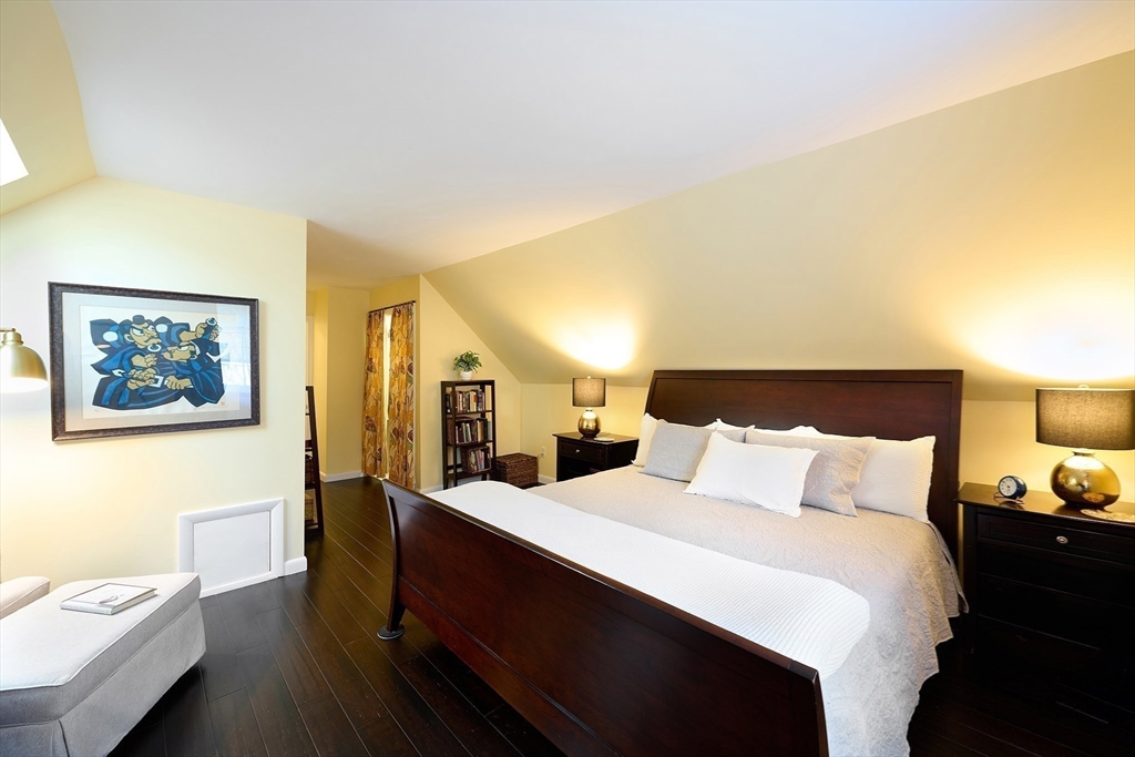 20 Manning Street, Unit 2 Ipswich, MA 01938 - Photo 18 of 27 a bedroom with a bed and wooden floor