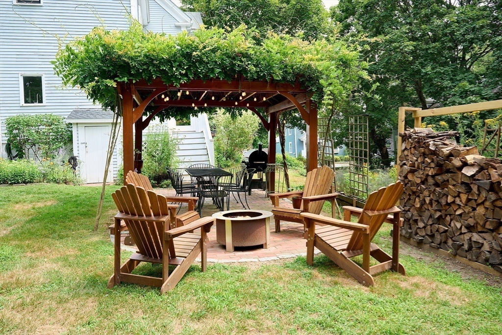 20 Manning Street, Unit 2 Ipswich, MA 01938 - Photo 23 of 27 a view of a chairs and table in backyard of the house