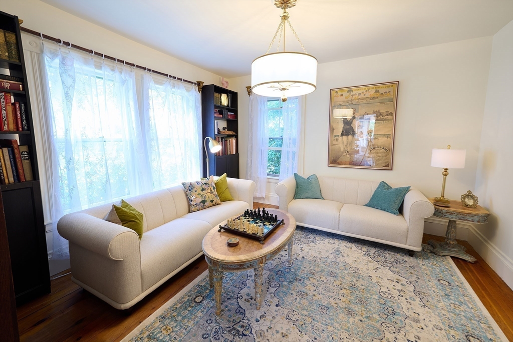 20 Manning Street, Unit 2 Ipswich, MA 01938 - Photo 8 of 27 a living room with furniture a chandelier and a window