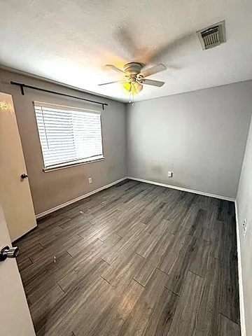 a bedroom with a bed and a mirror