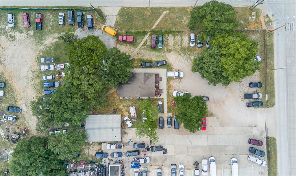 3410 House Anderson Road Euless, TX 76040 - Photo 5 of 18 Aerial perspective showcasing a parcel with multiple structures and extensive paved and unpaved areas