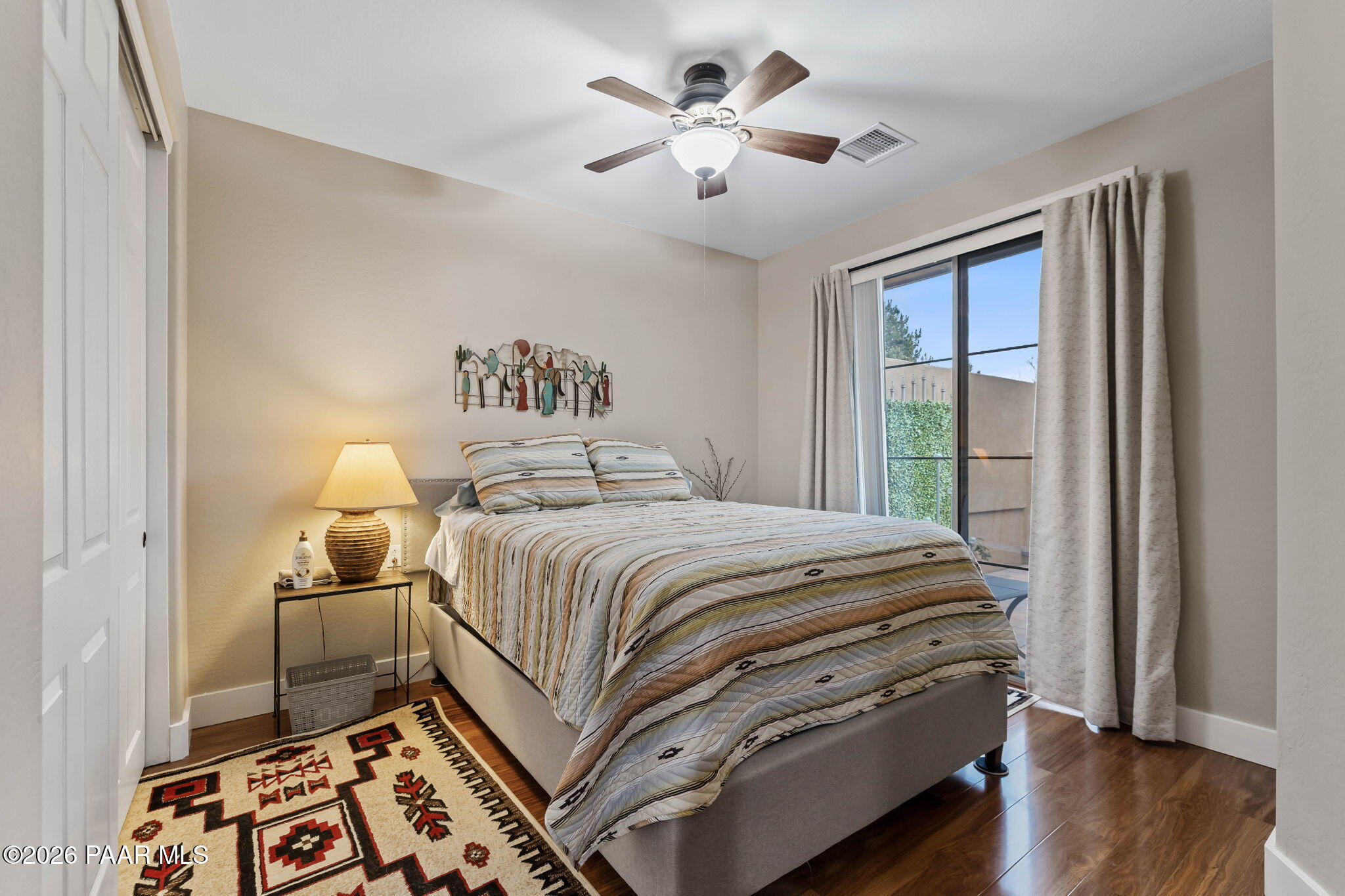 1242 Crown Ridge Drive Prescott, AZ 86301 - Photo 12 of 22 a bedroom with a bed and a lamp on the dresser
