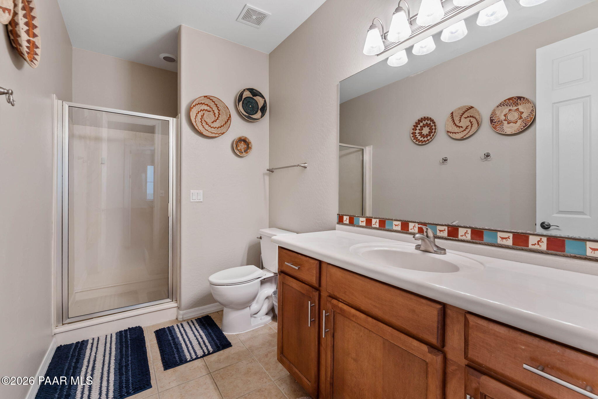 1242 Crown Ridge Drive Prescott, AZ 86301 - Photo 13 of 22 a bathroom with a sink a toilet a mirror and shower