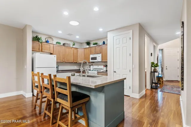 a kitchen with a table chairs refrigerator and microwave