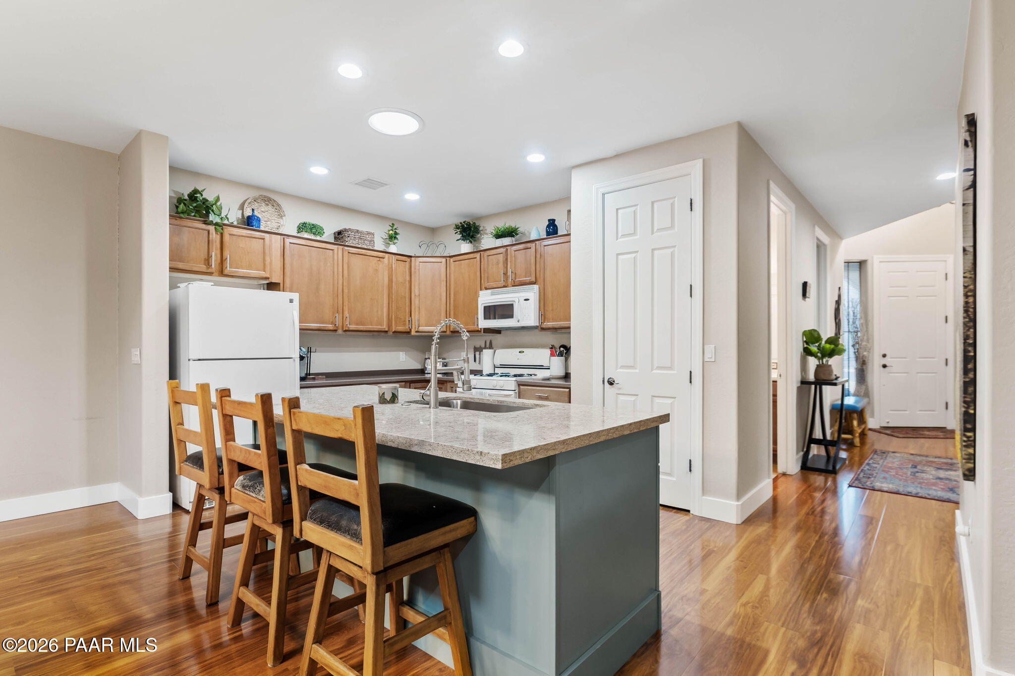 1242 Crown Ridge Drive Prescott, AZ 86301 - Photo 8 of 22 a kitchen with a table chairs refrigerator and microwave