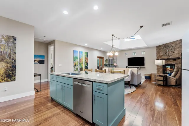 a kitchen with a sink and wooden floor