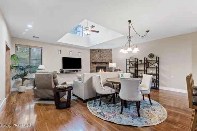 a view of a dining room with furniture a chandelier and wooden floor