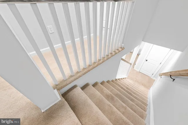 a view of staircase with rug