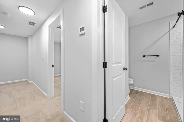 a view of a hallway with wooden floor