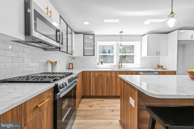a kitchen with stainless steel appliances granite countertop a stove and a sink