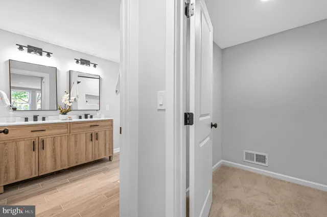 a spacious bathroom with a double vanity sink and a mirror