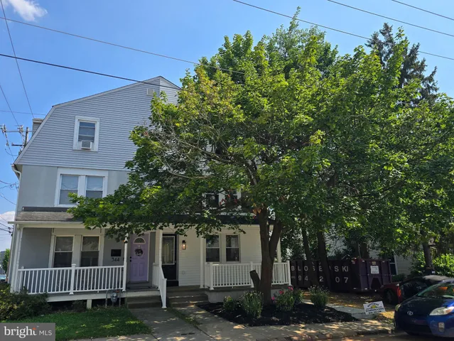 front view of a house with a tree