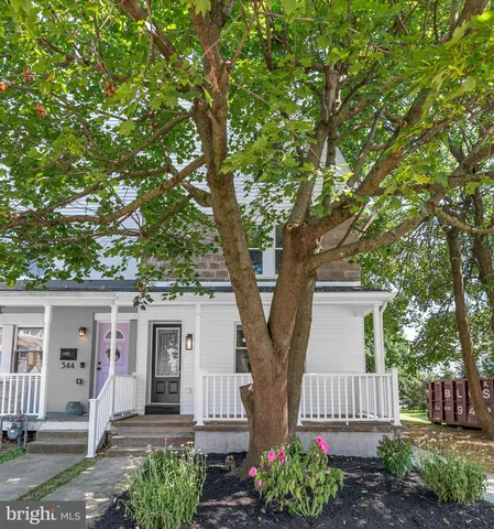 front view of a house with a tree