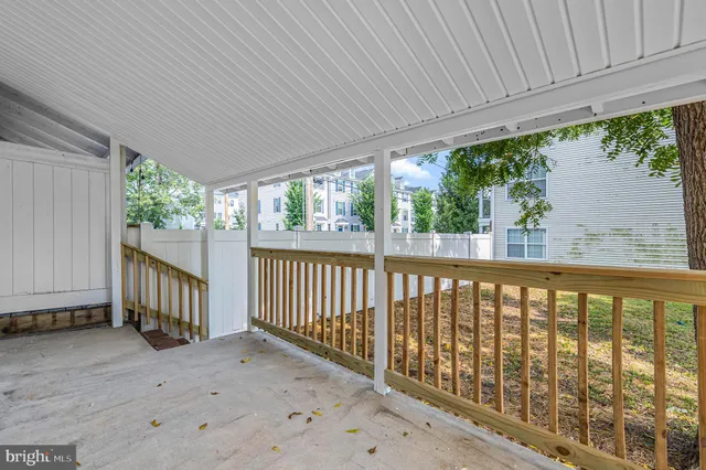 a view of a porch with wooden floor and roof