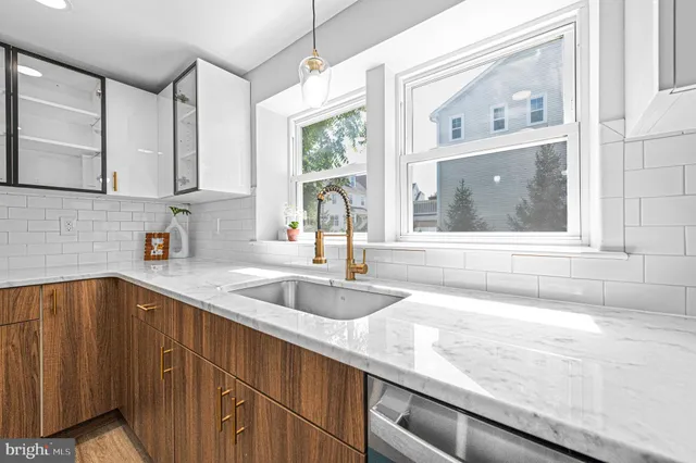 a kitchen with granite countertop a sink and a window