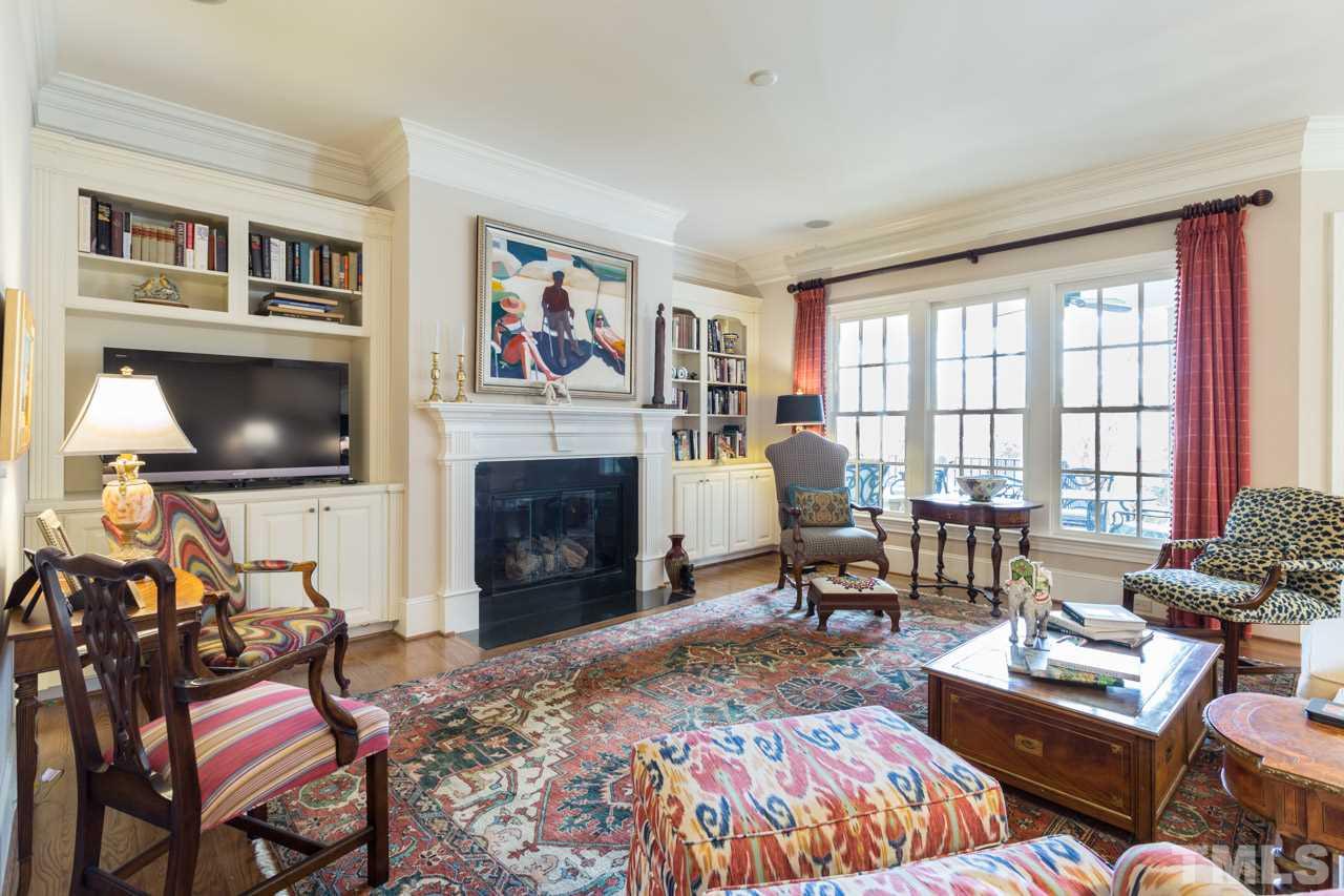 2308 Beechridge Road Raleigh, NC 27608 - Photo 17 of 27 a living room with furniture a flat screen tv and a fireplace