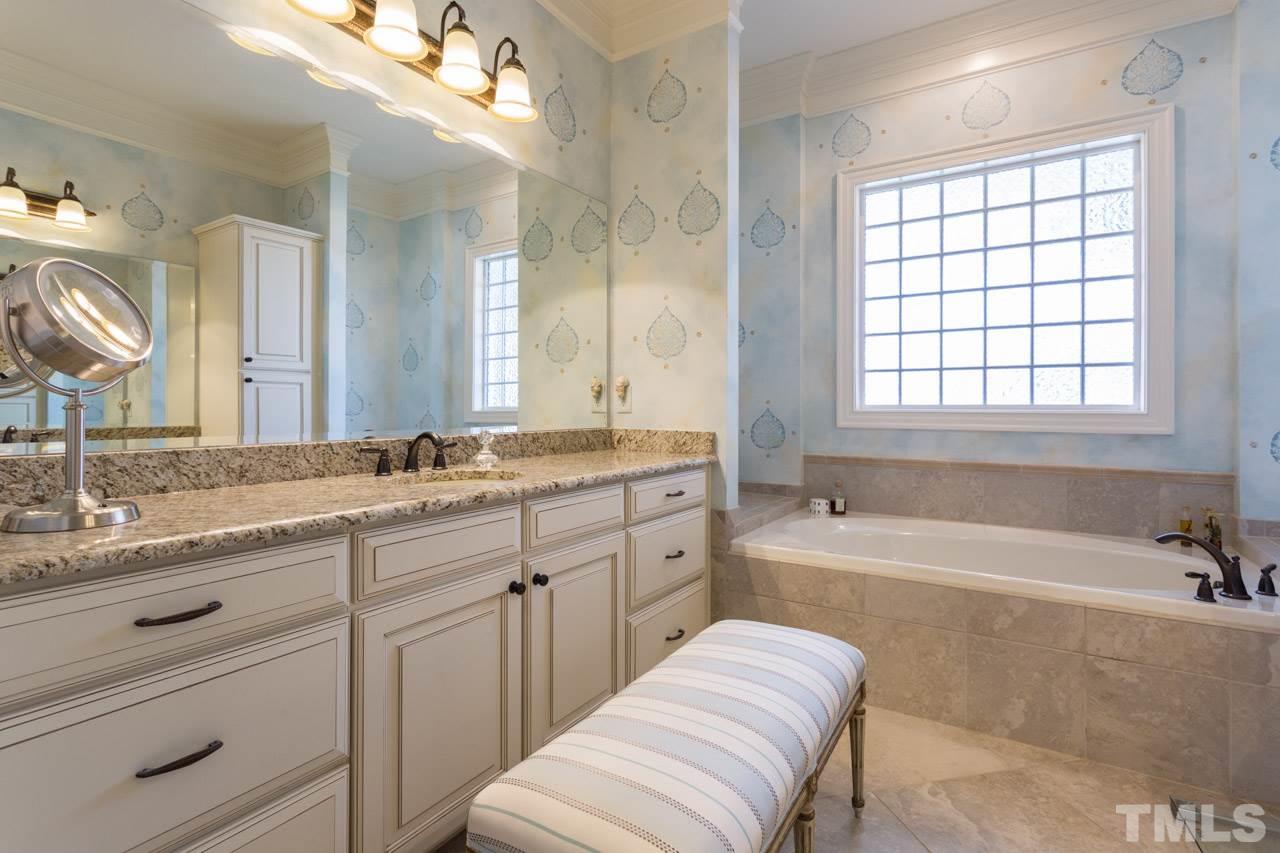 2308 Beechridge Road Raleigh, NC 27608 - Photo 20 of 27 a spacious bathroom with a granite countertop tub sink and mirror