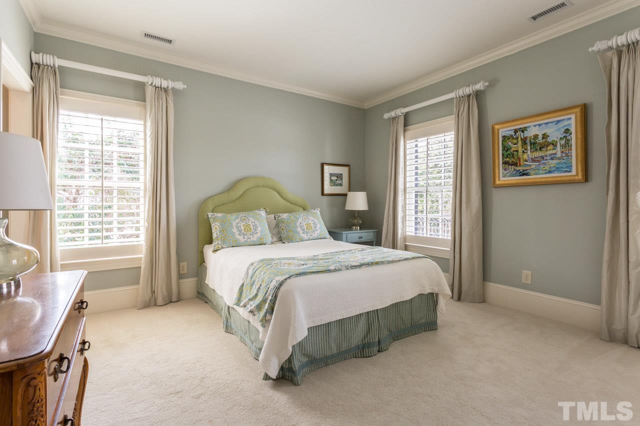 2308 Beechridge Road Raleigh, NC 27608 - Photo 21 of 27 a bedroom with a bed chair and a window