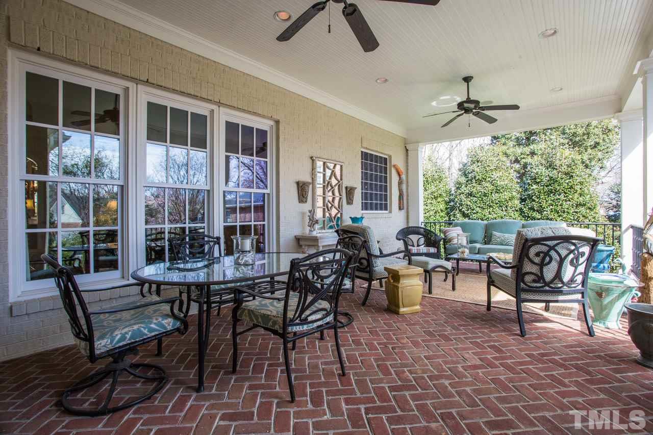 2308 Beechridge Road Raleigh, NC 27608 - Photo 25 of 27 a outdoor space with lots of chairs a chandelier and a rug