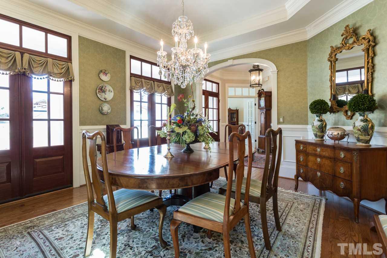 2308 Beechridge Road Raleigh, NC 27608 - Photo 9 of 27 a view of a dining room with furniture and chandelier