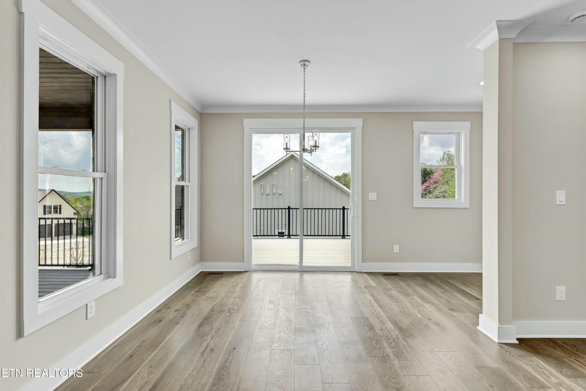 819 Anchor Vista Road Knoxville, TN 37934 - Photo 12 of 31 an empty room with wooden floor and a ceiling fan