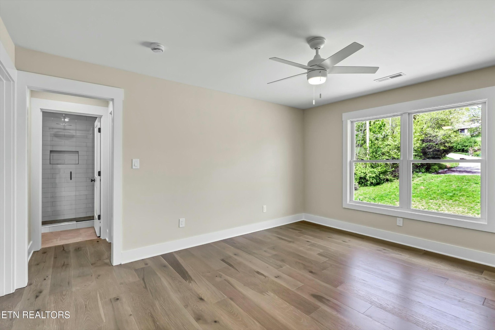 819 Anchor Vista Road Knoxville, TN 37934 - Photo 23 of 31 an empty room with wooden floor fan and windows