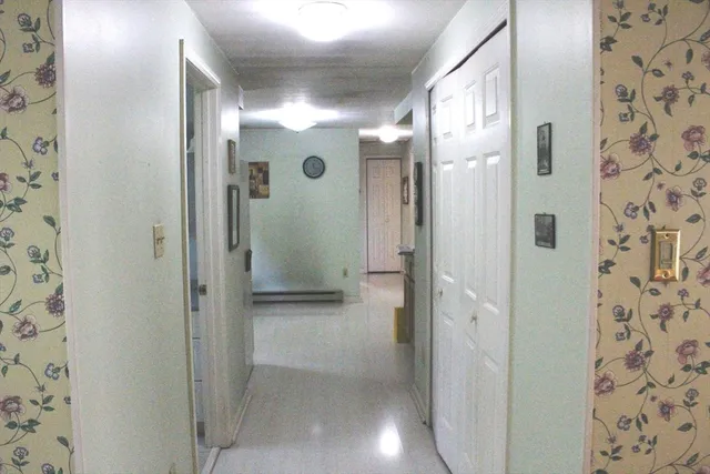 a bathroom with a granite countertop toilet and a sink