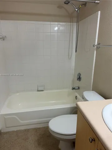 a bathroom with a toilet and a bath tub
