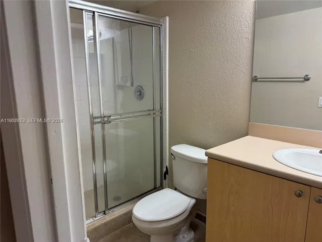 a white toilet sitting next to a bathroom sink
