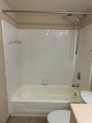 a bathroom with a shower and a toilet