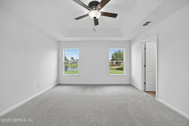 a view of room with window and ceiling fan