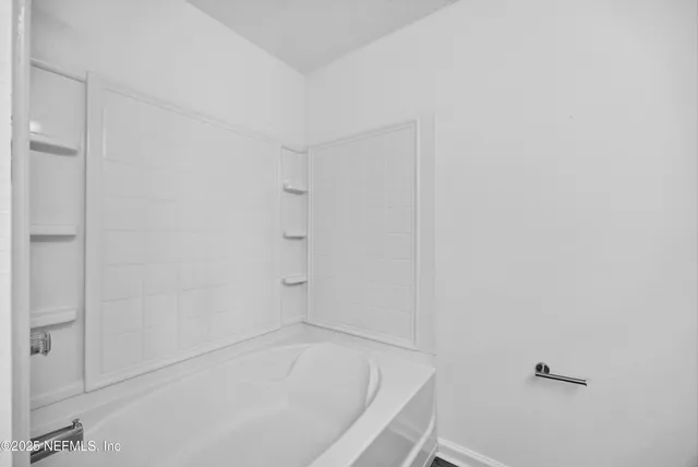 a white bath tub sitting in a bathroom