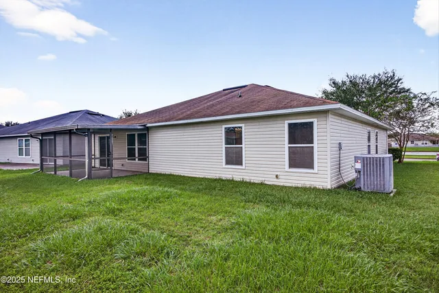 a backyard of a house with table and chairs