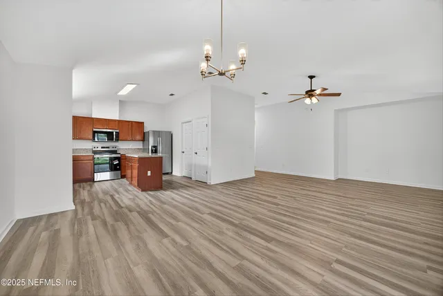a view of a kitchen with microwave and furniture