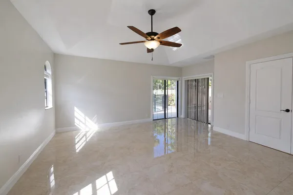 a view of a livingroom with a ceiling fan and window
