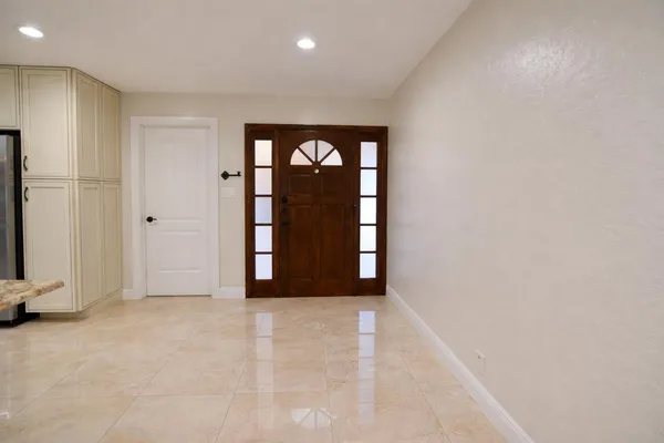 an empty room with windows and closet